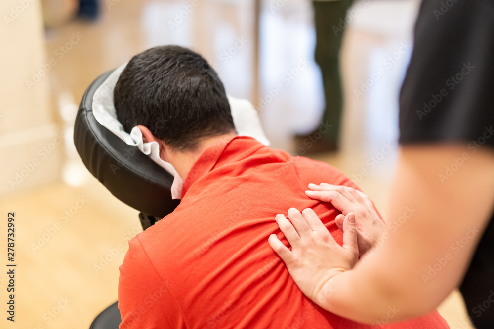 Man receiving shiatsu on a quick massage chair